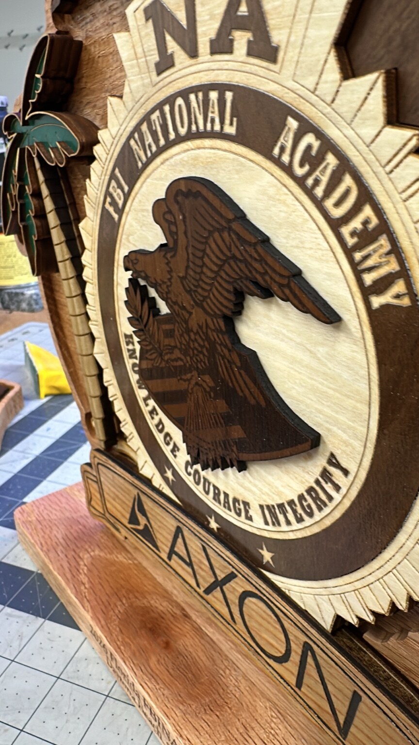 Close-up detail of a layered wooden sponsor plaque