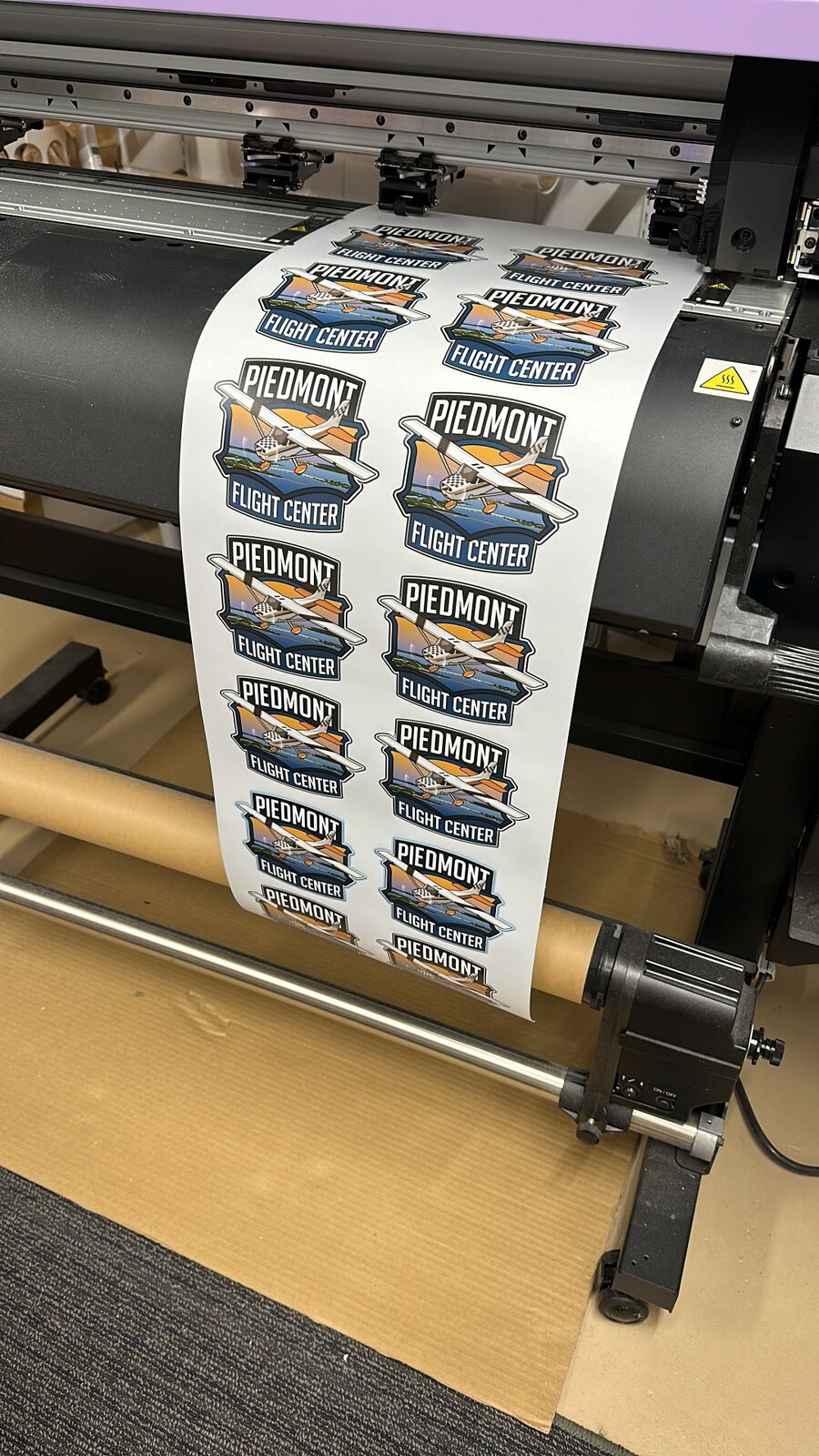 Wide-format printer producing custom vinyl decals